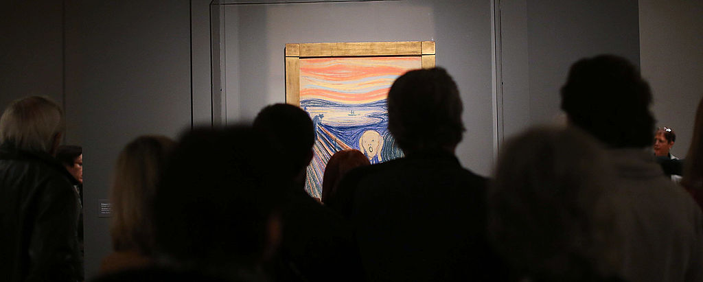 NEW YORK, NY - OCTOBER 25: People look at Edvard Munch's "The Scream," which went on display in Manhattan's Museum of Modern Art (MOMA) for a six-month exhibition October 25, 2012 in New York City. The Norwegian artist's most famous motif, and one of the world's most iconic paintings, sold for nearly $120 million at Sotheby's auction house in May and is the only one of four versions that is in private hands. (Photo by Spencer Platt/Getty Images)
