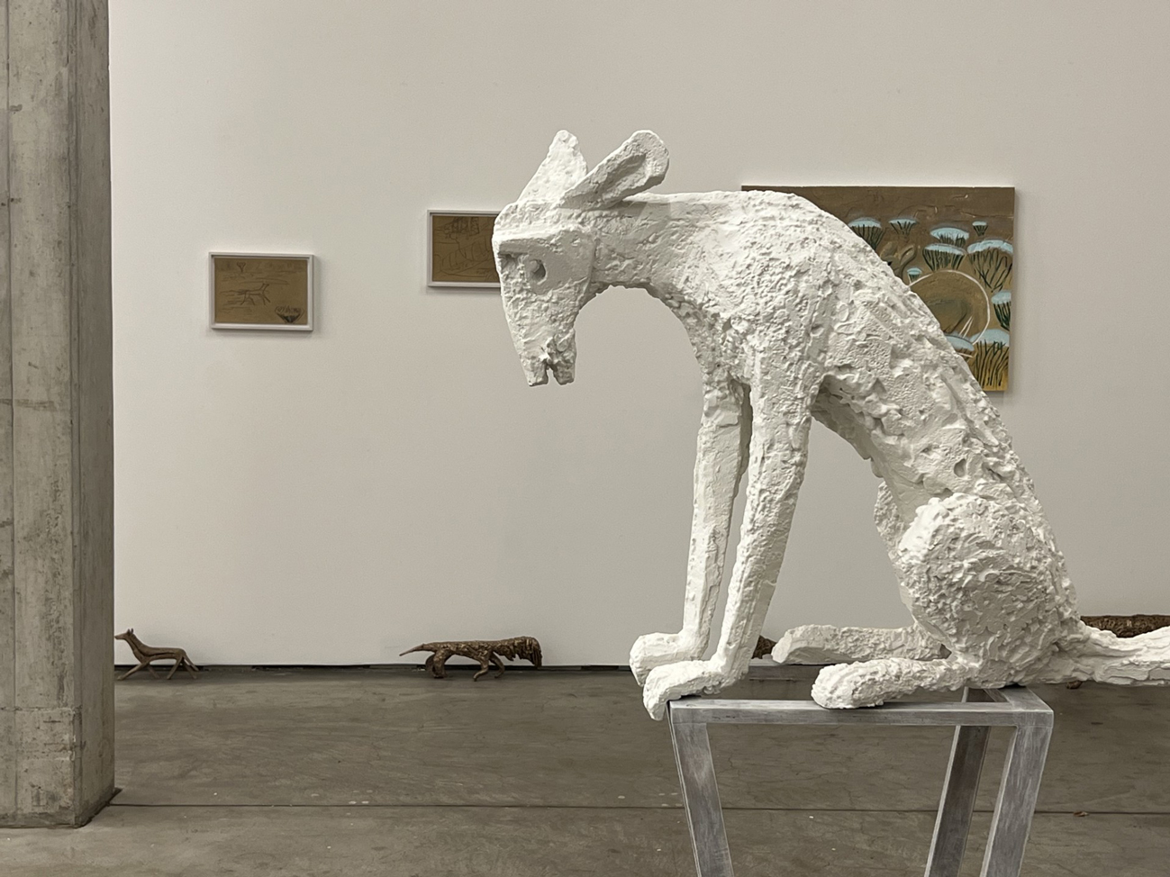A sculpture of an animal stands on a plinth.